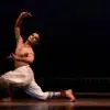 Adithya P.V., Indian classical dancer, performing in a Bharatanatyam-inspired pose during a stage production.