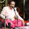 Hindustani vocalist Muddu Mohan performing on stage with tabla accompaniment during a classical music concert.