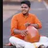 R. A. Rohith seated with a ghatam during a Carnatic classical percussion performance.