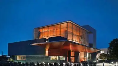 Exterior view of The Broad Stage performing arts theatre in Santa Monica, Los Angeles, illuminated at night.