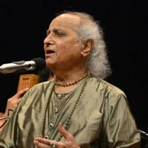 Pandit Jasraj performing Hindustani classical vocal music on stage.