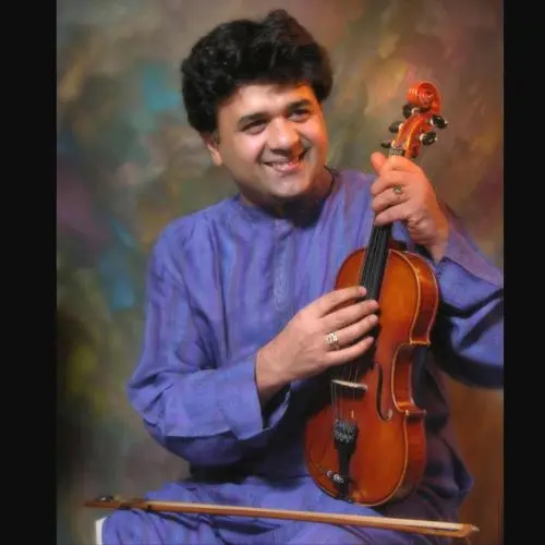 Portrait of Carnatic violinist Ganesh Rajagopalan holding a violin, known as part of the Ganesh–Kumaresh violin duo in South Indian classical music.