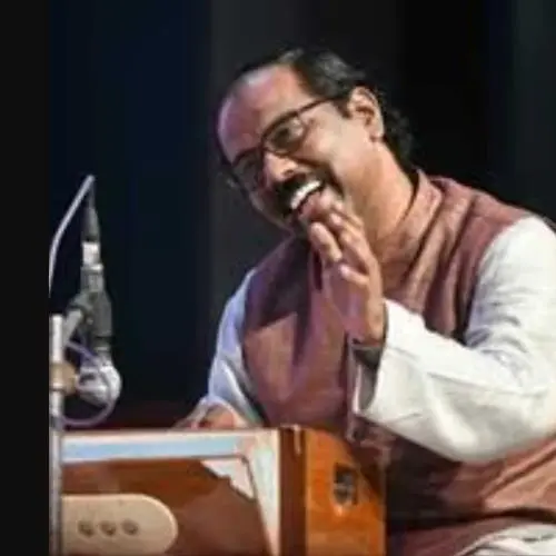 Harmonium player Vyasmurti Katti performing during a Hindustani classical music concert.