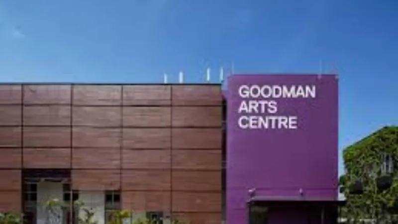 Exterior view of Goodman Arts Centre in Singapore, showing the building facade with the “Goodman Arts Centre” sign on a purple wall and surrounding greenery.